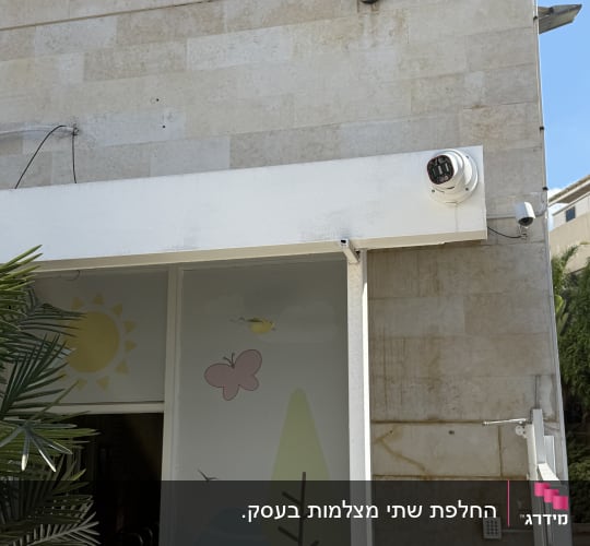 קודן ומצלמות אבטחה מותקנים בחזית מבנה ליד שער כניסה